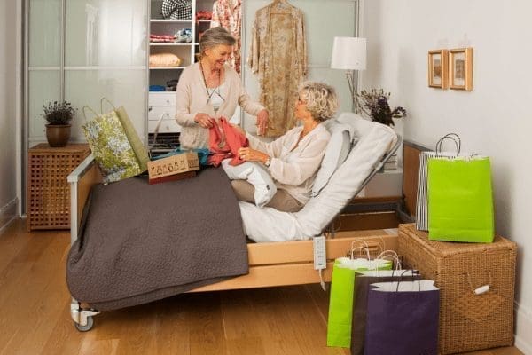 woman in profiling bed talking to a friend